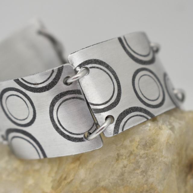 graduating circles aluminum bracelet.jpg